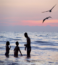 family at seaside sunset